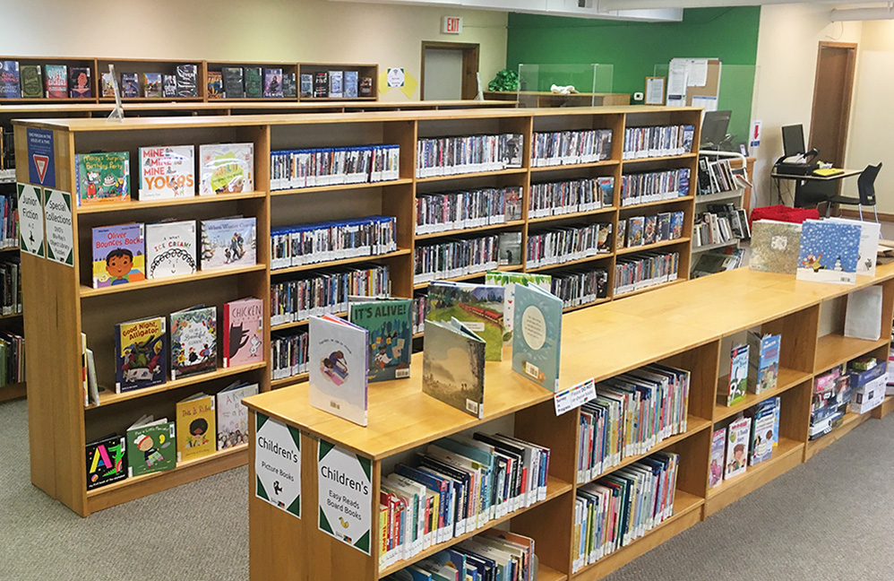 Interior photo of the Blyth Branch with the back wall painted green to match their branch colour.